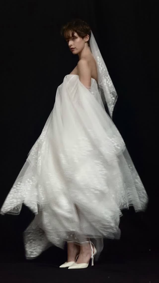 NEW ARRIVAL: Lilia by @wedstudio_.A study in contrast—sharp, structured tulle softened by a draped flag hem and delicate floral lace trim. A corseted bodice anchors the silhouette, balancing volume with precision.Now at LOHO. Book your bridal appointment via the link in our bio to experience Lilia in person. by @loho_bride